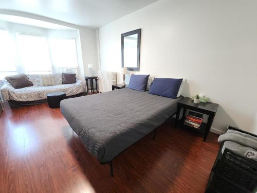 una camera da letto con un letto grande e un divano di Cozy Apartment- Quick Walk to Boardwalk & Casinos ad Atlantic City