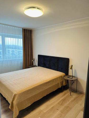 a bedroom with a large bed and a window at Seaside Escape in Pärnu