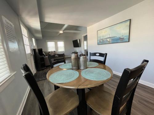 a dining room with a wooden table and chairs at The Beacon Ocean City- 7 Bedrooms, Close to All! in Ocean City