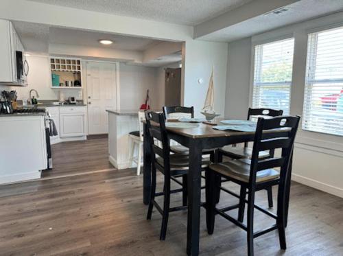 a kitchen and dining room with a table and chairs at The Beacon Ocean City- 7 Bedrooms, Close to All! in Ocean City