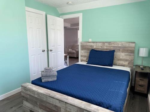 a bedroom with blue walls and a bed with blue sheets at The Beacon Ocean City- 7 Bedrooms, Close to All! in Ocean City