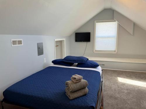 a bedroom with a bed with towels on it at The Beacon Ocean City- 7 Bedrooms, Close to All! in Ocean City