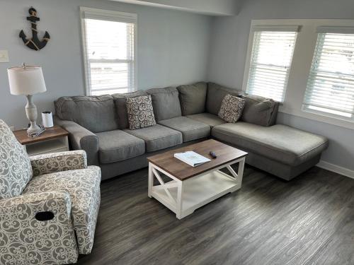 a living room with a couch and a table at The Beacon Ocean City- 7 Bedrooms, Close to All! in Ocean City