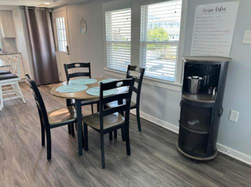 a dining room with a table and chairs and a trash can at The Beacon Ocean City- 7 Bedrooms, Close to All! in Ocean City