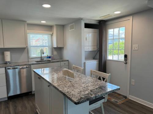 a kitchen with a granite counter top and a kitchen island at The Beacon Ocean City- 7 Bedrooms, Close to All! in Ocean City