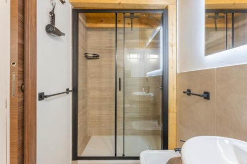 a glass shower in a bathroom with a sink at La carbonaia rooms in Agrigento in Agrigento
