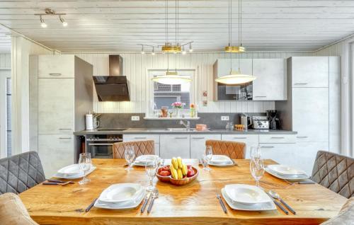 a kitchen with a wooden table with a bowl of fruit on it at Beautiful Home In Zerpenschleuse in Zerpenschleuse