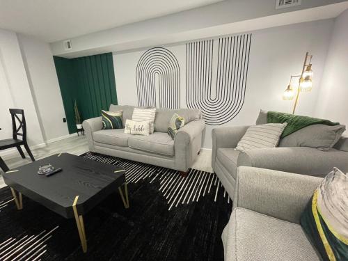 a living room with two couches and a coffee table at Posh Paradise -Modern Close to Casino & Water Park in Atlantic City