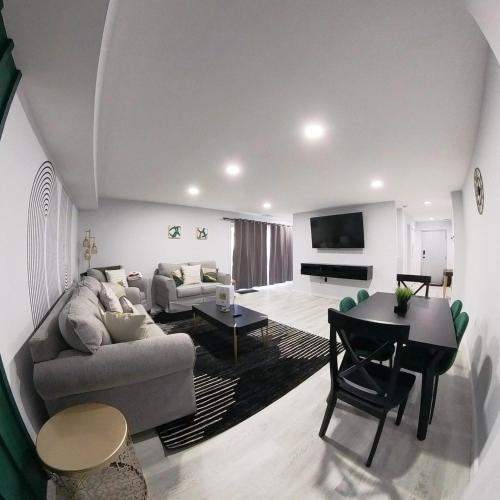 a living room with a couch and a table at Posh Paradise -Modern Close to Casino & Water Park in Atlantic City