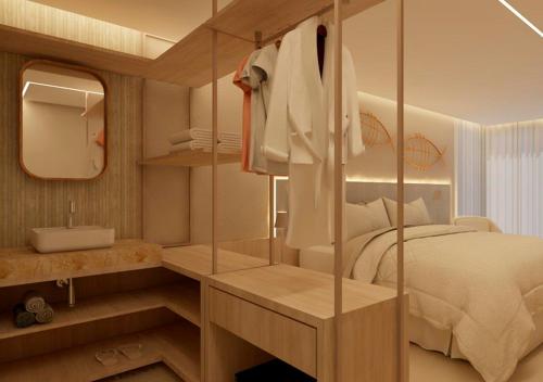 a bedroom with a bed and a sink and a mirror at Pousada Filó in Fernando de Noronha