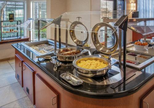 a buffet with bowls of food on a counter at Staybridge Suites Rocklin - Roseville Area by IHG in Rocklin