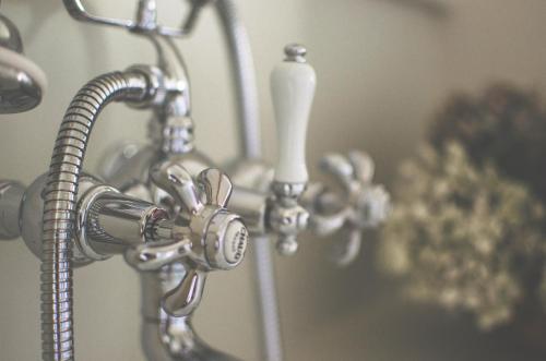 a close up of a shower faucet in a bathroom at Monastere de Brucourt in Brucourt