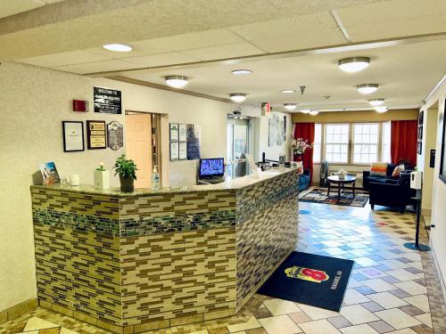 a lobby with a bar in a hospital at Super 8 by Wyndham Maumee Perrysburg Toledo Area in Maumee