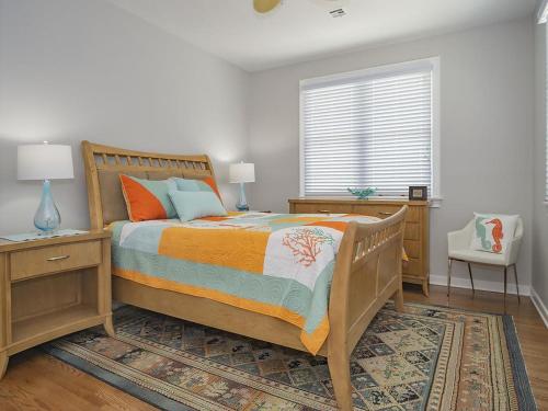a bedroom with a wooden bed and a window at Oceanfront Ocean Views Wifi Beach Badges Decks Spectacular Oceanfront -- With Fantastic Views -- Located In Prestigious Harvey Cedars Just in Harvey Cedars