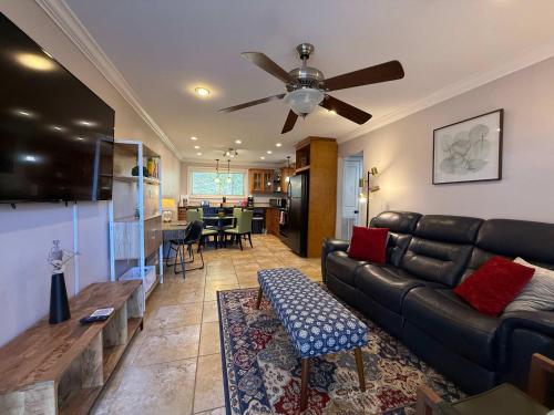 a living room with a couch and a ceiling fan at 2 BR apartment with laundry pool in Baton Rouge