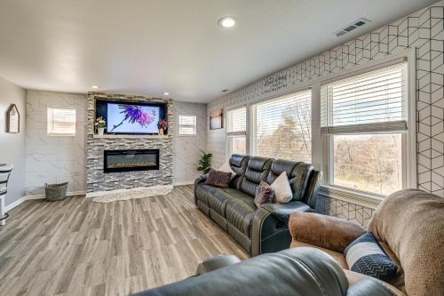 a living room with a couch and a tv at 5 Mi to Dtwn Family-Friendly Home in Roanoke! in Roanoke