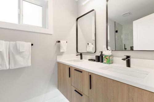 a bathroom with two sinks and a mirror at Modern Ballard Retreat Near Beach & Parks in Seattle