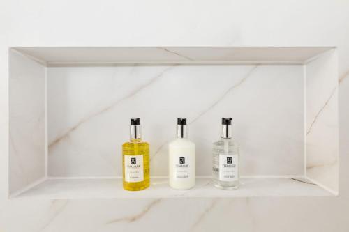a white shelf with three bottles on it at Modern Ballard Retreat Near Beach & Parks in Seattle