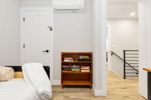 a bedroom with a bed and a book shelf at Modern Ballard Retreat Near Beach & Parks in Seattle