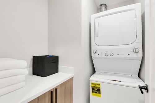 a white washer and dryer sitting on a shelf at Modern Ballard Retreat Near Beach & Parks in Seattle