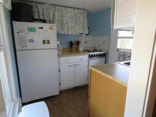 a kitchen with a white refrigerator and a stove at Bay Views! Wifi Bay Side Duplex In Ship Bottom in Ship Bottom