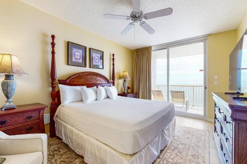 a bedroom with a large bed and a balcony at The Beach Club 1102B in Gulf Highlands