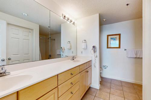 a bathroom with a sink and a large mirror at The Beach Club 1102B in Gulf Highlands