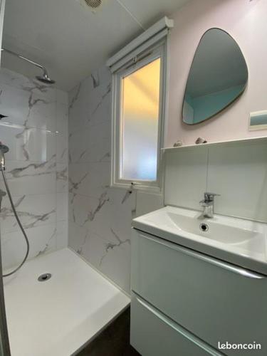 une salle de bain blanche avec un lavabo et un miroir dans l'établissement mobil home de luxe, au Pradet