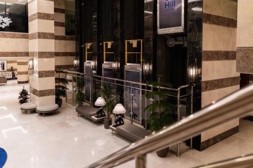 a lobby of a building with stairs and plants at فندق هيل Hill Hotel in Al Madinah