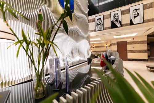 an office with a row of chairs and a plant at فندق هيل Hill Hotel in Al Madinah