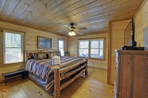 a bedroom with a large bed with a ceiling fan at Majestic View in Mashburn Mill