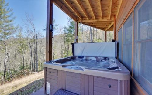a hot tub in the back of a house at Majestic View in Mashburn Mill