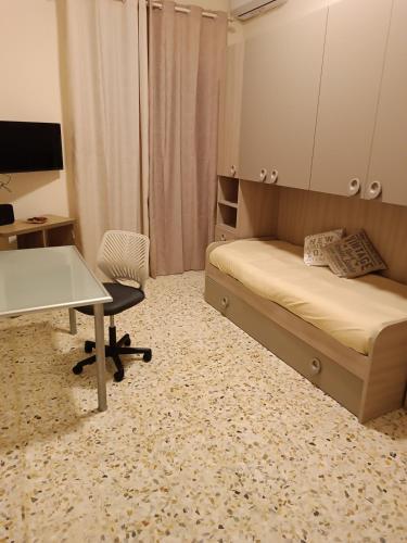 a bedroom with a bed and a desk and a table at La Casa di Carlotta in Naples