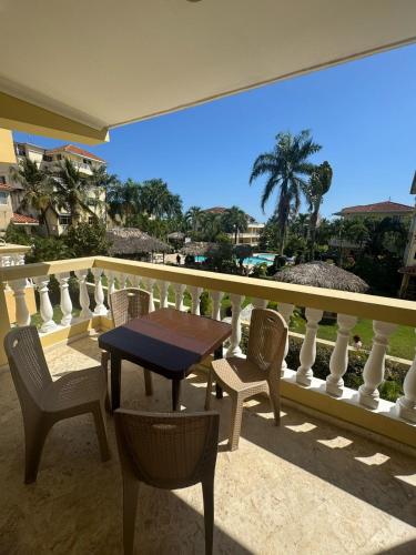 a patio with a table and chairs on a balcony at Las Palmeras by Graziano in Boca Chica