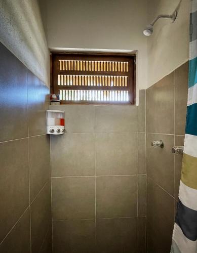 a bathroom with a shower and a window at Cabañas Uma 2 in San Agustinillo