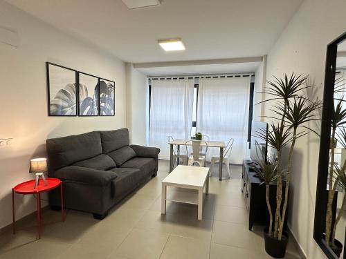 a living room with a couch and a table at Apartamentos Vernia 3-9 in Xàtiva
