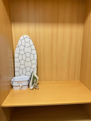 a wooden shelf with a figurine of a rock on it at Apartamentos Vernia 3-9 in Xàtiva