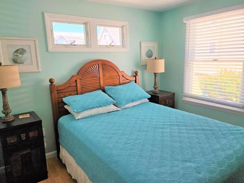 a bedroom with a bed with blue sheets and two lamps at Brant Beach - Lovely, 2Nd Floor Duplex, Only 3 Houses From The Beach With Great Oceanviews From Both The Livdin Area And The Deck No Smoking, And in Brant Beach