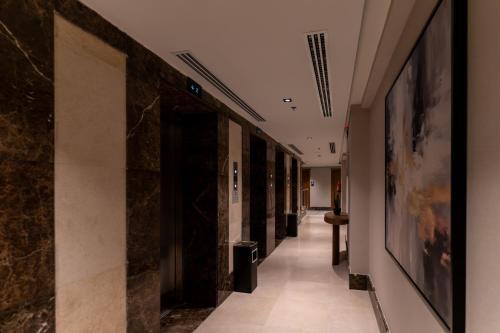 a hallway in a building with paintings on the walls at فندق هيل Hill Hotel in Al Madinah