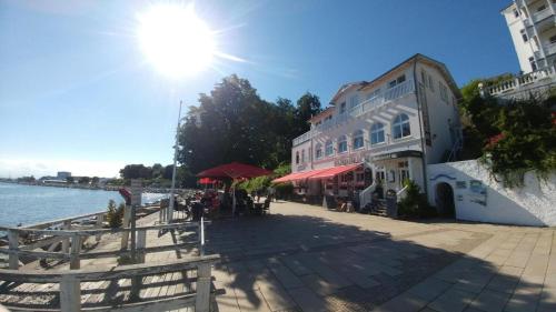 a building on the side of a body of water at Pension Ostseeblick in Sassnitz