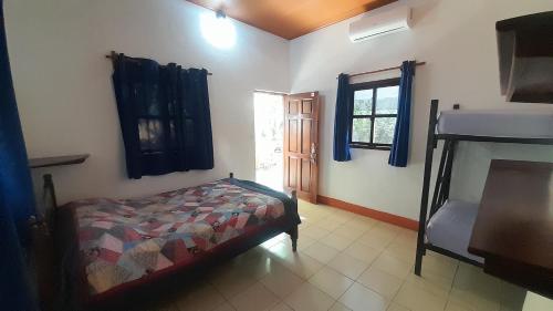 a bedroom with a bed and a bunk bed at Rancho de Pedro in El Viejo