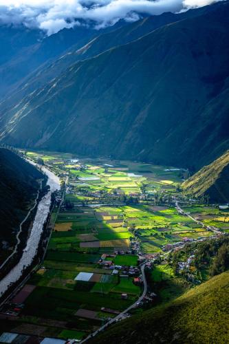 an aerial view of a town next to a river at Vertical Sky Suites in Ollantaytambo
