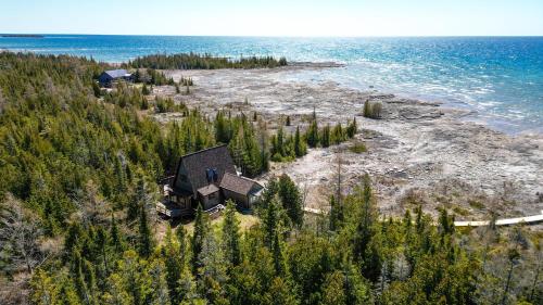 an aerial view of a house on a island in the water at Lands End Private Lakeside Escape in Tobermory