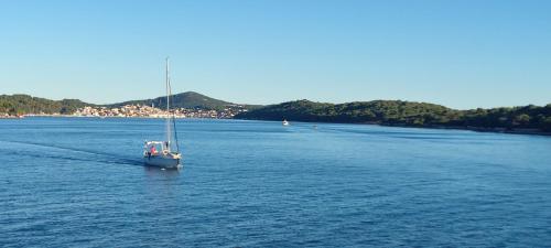 a boat floating in a large body of water at Sea view Anika by Vellaris, Luxury Mobile Home in Mali Lošinj