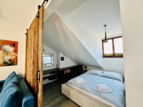 a bedroom with a bed in a attic at Apartament Metamorfoza in Nowy Targ