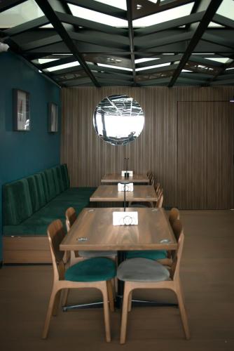 a dining room with a table and chairs and a couch at Hotel Flamencos Centro Histórico in Mexico City