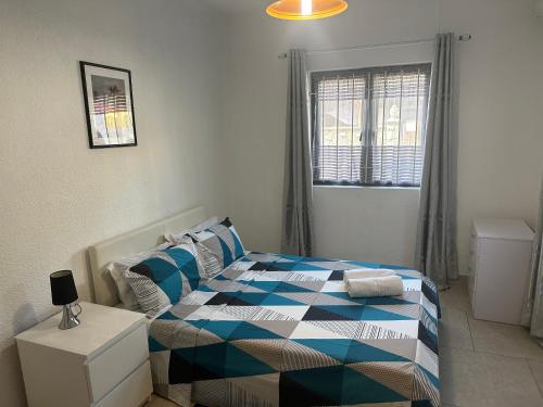 a bedroom with a bed with a blue at Ibis Tourist Residence 1 in Mahébourg