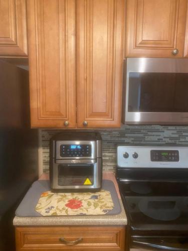 a kitchen with a toaster oven and a microwave at paradise vacation luxury home in Palm Bay