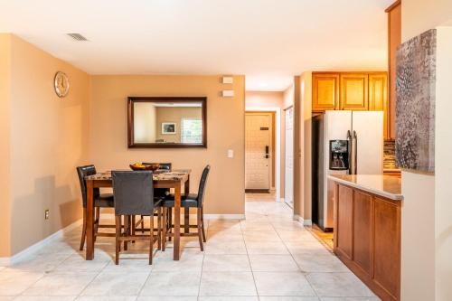 a kitchen and dining room with a table and chairs at paradise vacation luxury home in Palm Bay