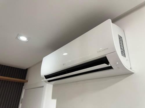 a white microwave oven hanging from a ceiling at Apart Moderno Proximo ao Mar in Vila Velha